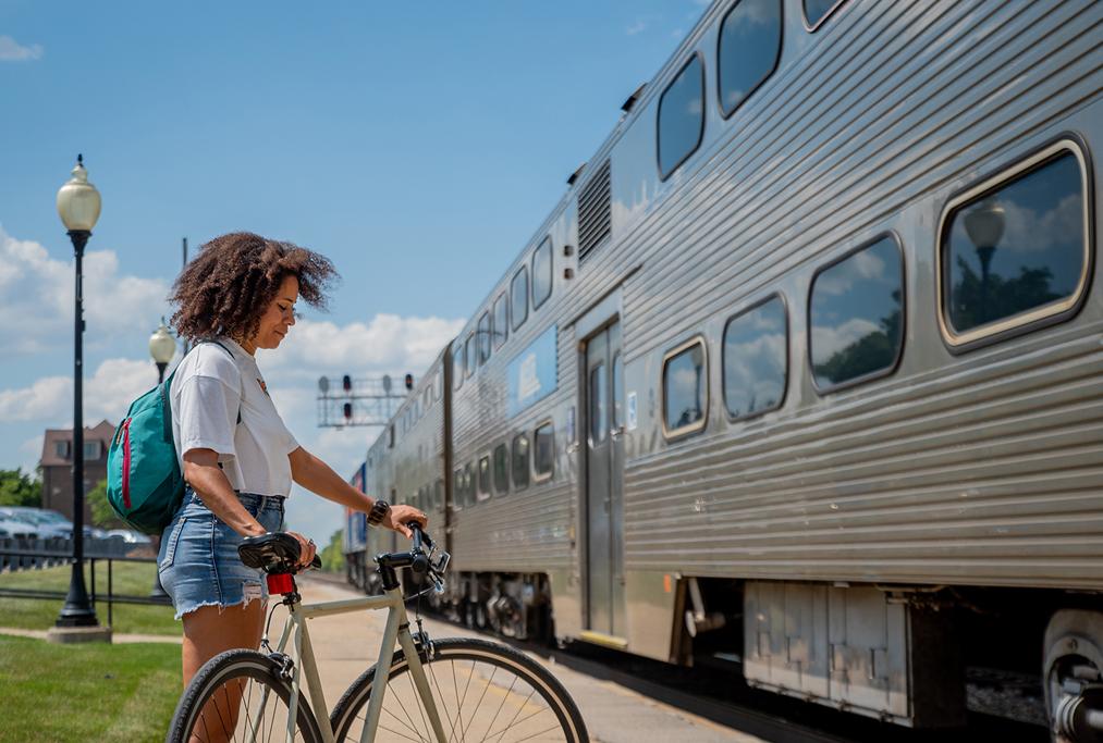 Woman with bike boarding Metra train